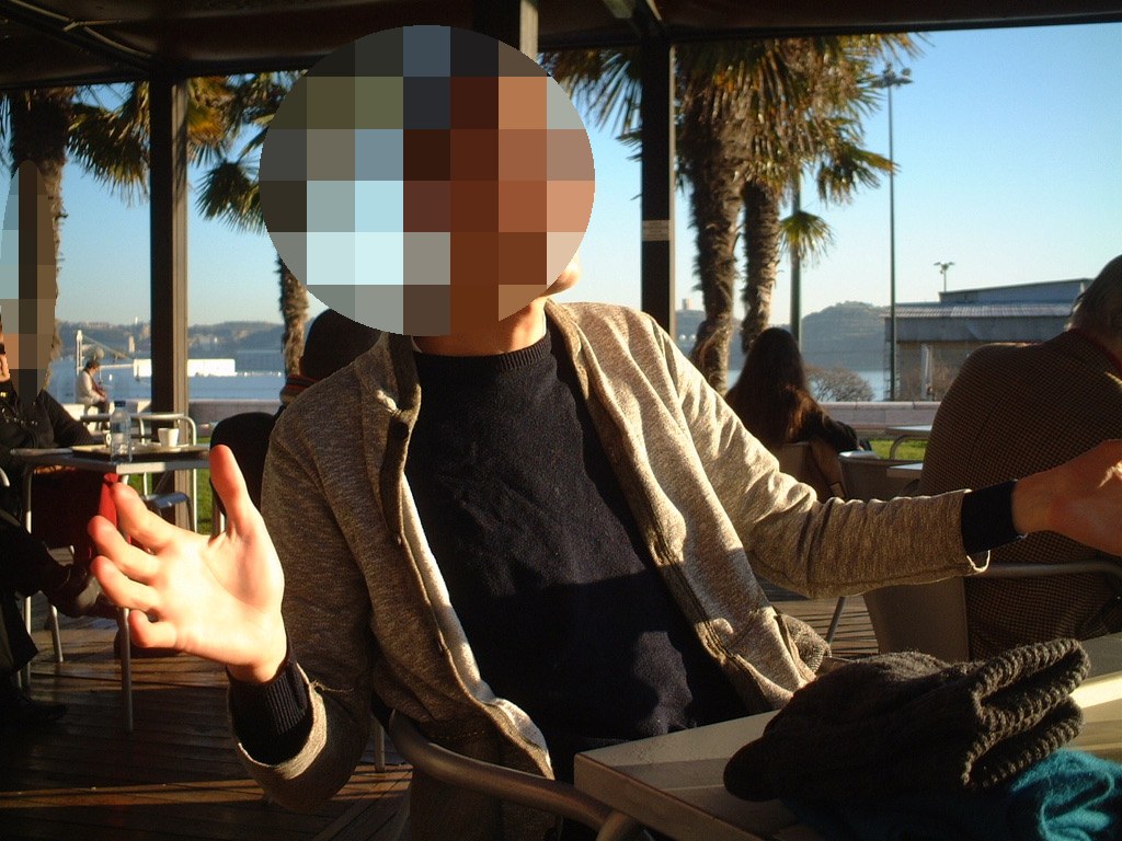 Joa laughing at an outdoor café in Portugal in 2006